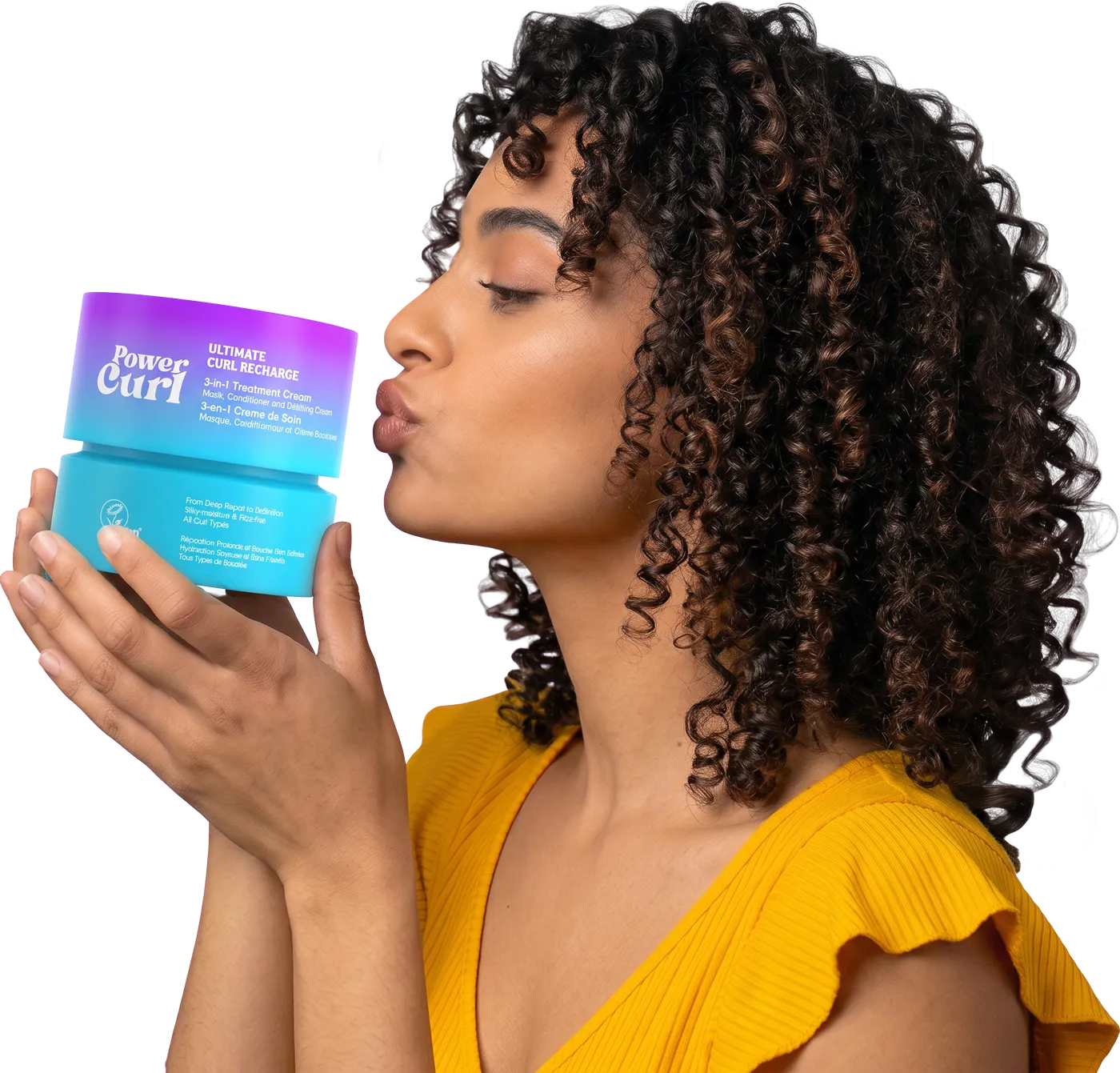 Woman with curly hair blowing a kiss to a jar of Power Curl Ultimate Curl Recharge treatment cream