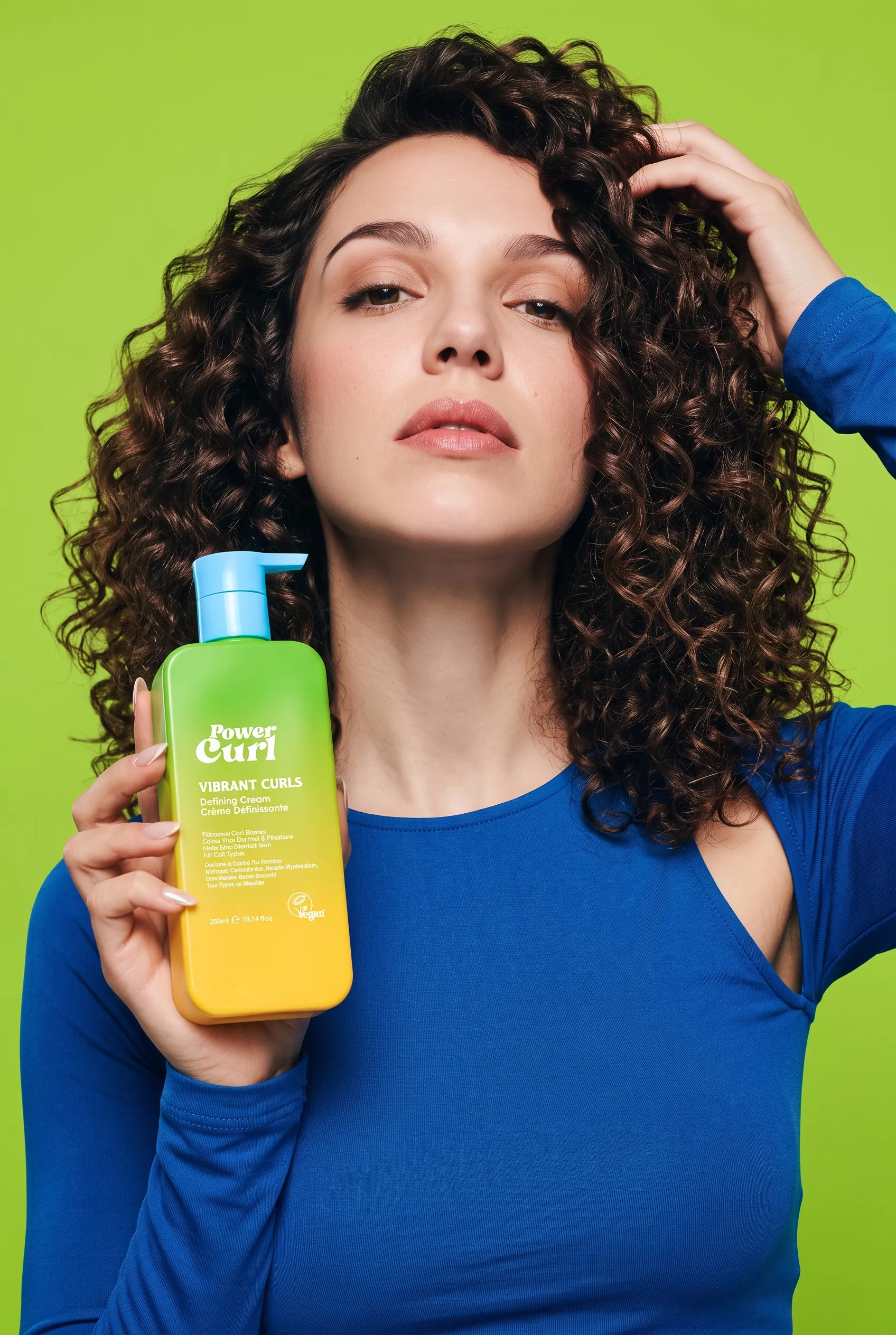 Woman with curly hair holding Power Curl Vibrant Curls defining cream